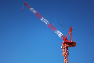 Tokyo,Japan-December 24, 2018: A Giant Red Climbing Crane with blue sky background 
