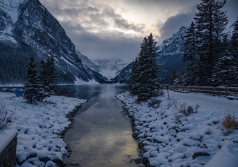 Lake Louise Banff Canada during the winter season. Blue hour after sunset on a cold winter night. Still glacial lakes in the Canadian Rockies. First snow fall at Lake Louise.