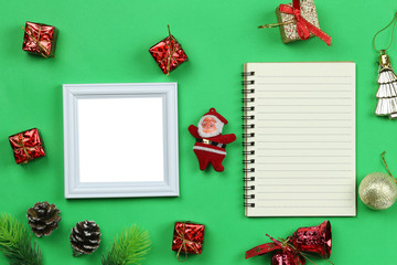 Christmas decoration equipment and photo frame on green paper art background.