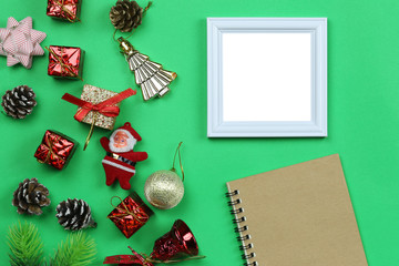 Christmas decoration equipment and photo frame on green paper art background.