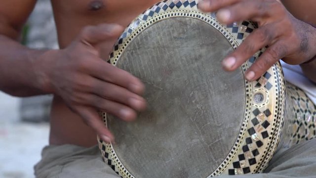 Man playing on a Bongo drum close up. Hand tapping a Bongo drum in close up.  Drummer hands, movement, rhythm.  Koh Phangan island, Thailand