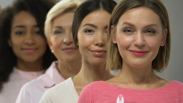 Women of different races and ages with pink ribbon, breast cancer awareness