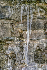 Icicle-covered limestone cliff in early winter in Ontario, Canada