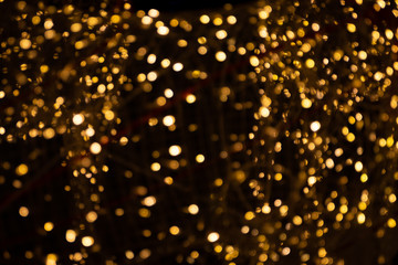 Gold yellow light abstract bokeh on black background