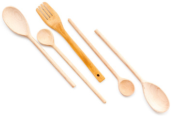 Woodenware set with spoons and forks on white background top view