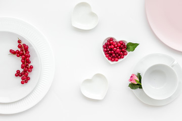 Empty white and pink colorful plate and wineberry for table setting on white table backgroung top view