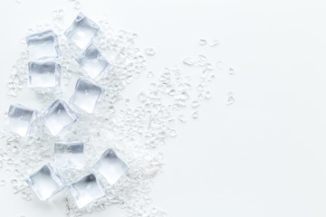 Obraz premium Frozen water in ice cubes on white bar table top view mockup