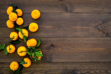 New Year and Christmas Eve with mandarins. Citrus winter fruits on wooden background top view space for text