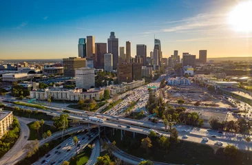 Deurstickers Drone view of downtown Los Angeles or LA skyline with skyscrapers and freeway traffic below. © Newport Coast Media