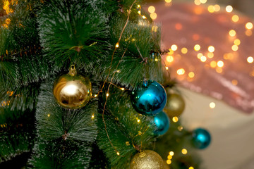 .Christmas tree decorated with blue and gold Christmas balls.