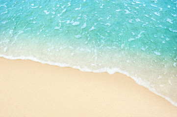 Fototapeta na wymiar Soft blue ocean wave on clean sandy beach