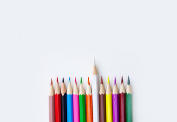 Variety color of crayon pencils with selective focus on the white color isolated on white background with copy space. View from above, Closeup. Wide banner.