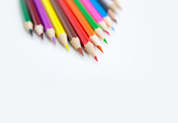 Art and drawing creativity concepts of colored crayon pencils on white background aligned with triangle shape at the corner with copy space. Top view, Close-up, For banner design.