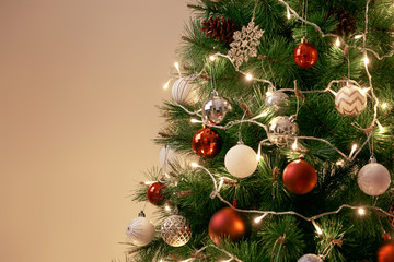 Decorated Christmas tree on blurred, sparkling and fairy background