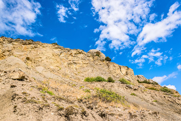 Mountain against the blue sky with white clouds