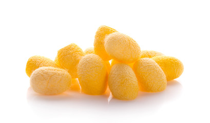 yellow thai silkworm cocoons pile isolated on white background