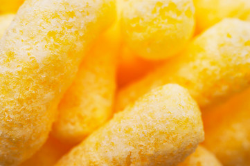 Closeup Image of Yellow Corn Puffs. Crunchy Flavored Puffed Snacks. Party, Movie, TV, Game Snacks.
