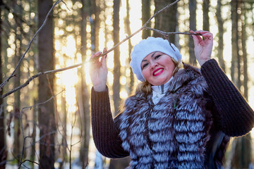 Portrait of beautiful plump woman in a nice winter forest
