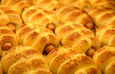 hot cross buns with sesame seeds in bakery shop.