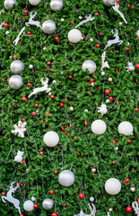 Fototapeta na wymiar golf ball on grass onChristmas tree, concept background.