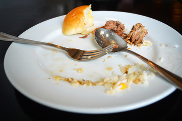Empty plate, dirty after the meal is finished breakfast / After eating food white plate with fork and spoon
