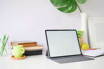 Workspace mockup tablet and office supplies on office desk.