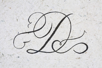 Calligraphy letter D - ink bleeding on kraft paper