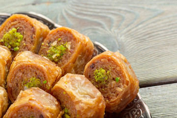 Delicious baklava dessert in oriental bronze setting close up