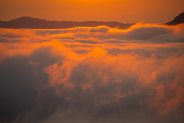 Beautiful dramatic sunset in the mountains. Landscape lot of fog Phu Thok Mountain at Chiang Khan ,Loei Province in Thailand.