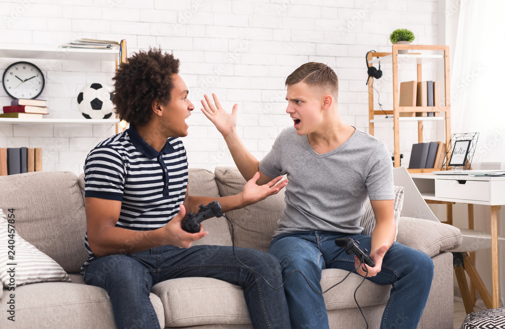 Wall mural teenage gamers arguing while playing on console