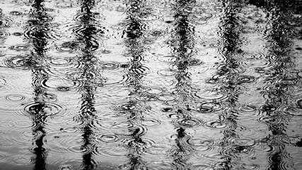 raindrops on floor with reflection from metal cage at the jail