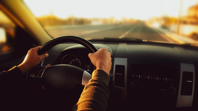 Man driving a car on the road.