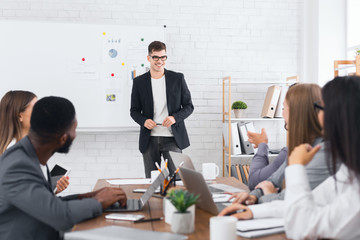 Director showing presentation on flipchart to his staff