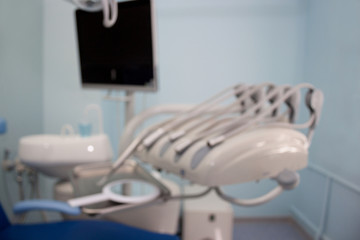 Dental treatment unit and other equipment with blur background. Dentist office.