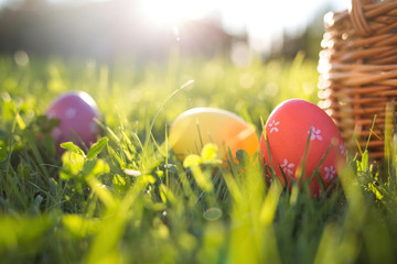 Easter eggs in a basket on the grass on a Sunny spring day close-up