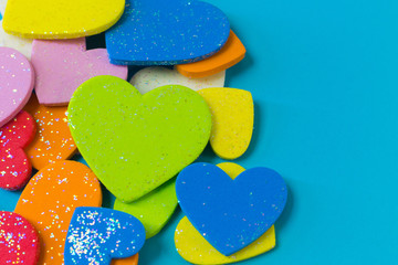 multi colour  heart on blue background close up image.