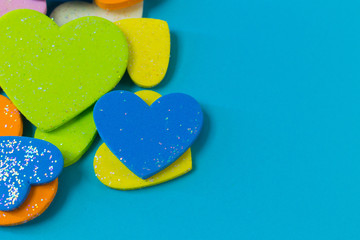 multi colour  heart on blue background close up image.