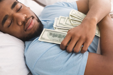 Man sleeping with lots of currency notes