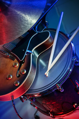 electric guitar, drum with sticks and plate