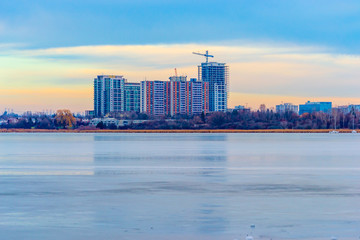 Fototapeta na wymiar reflection of buildings in frozen lake