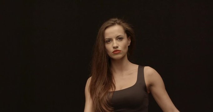 Vampire lady shows her whip and hits by it, female portrait, red lips, feeling bossy.