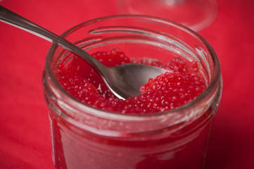closeup of red lumpfish roe in spoon on festive table