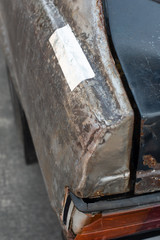 Details of a abandoned Japanese old car left on a street with interesting detail broken parts.