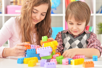 Obraz na płótnie Canvas Portrait of woman and boy playing blocks game
