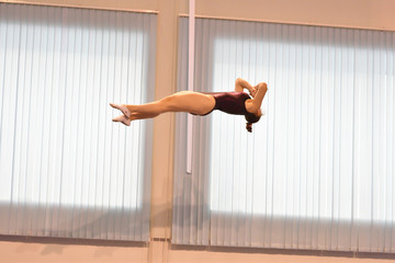 Girls compete in synchronous jumping on a trampoline