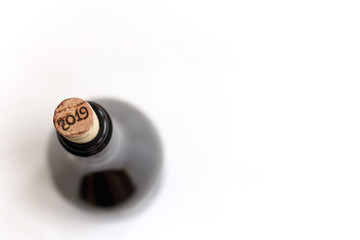 wine bottle with cork on a light background top view / holiday events 2019
