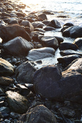 large sea stones washed by the waves and the sunset