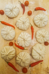Dish of traditional Oriental and Asian cuisine Manti with red hot peppers and tomatoes