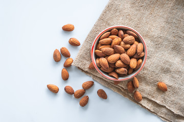 Almonds in cup on sack