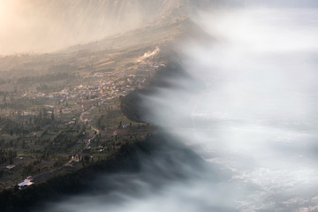 Cemoro Lawang village on mountain cliff with foggy in sunrise
